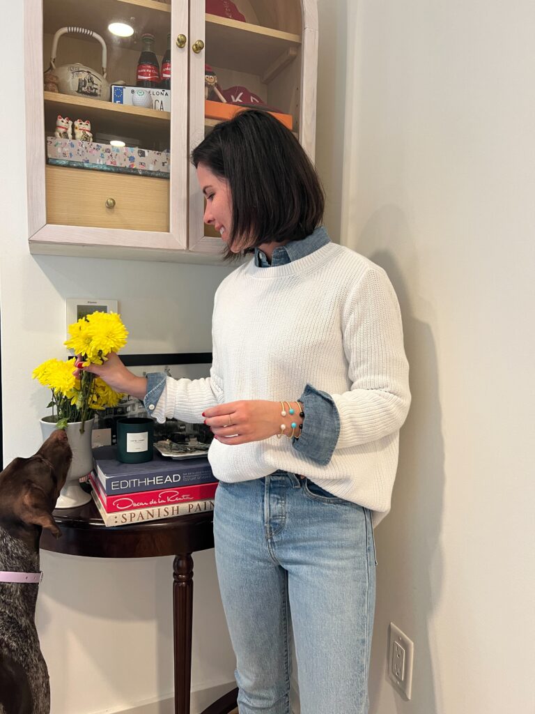 Effortless Layers: Styling a chic combo with a 525 America white sweater over a Polo Ralph Lauren denim shirt, paired flawlessly with light wash Levi's Wedgie Icon Fit jeans
